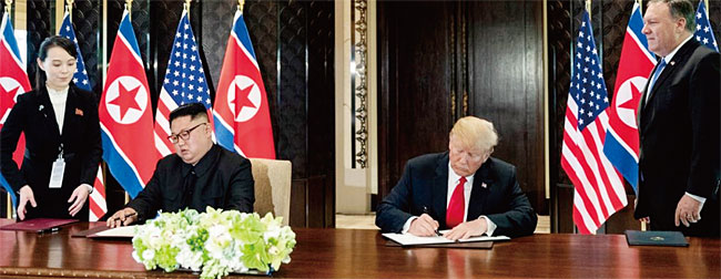 지난해 6월 1일 트럼프 미국 대통령과 김정은이 싱가포르 정상회담에서 합의한 공동성명서에 서명하고 있다. ⓒphoto 백악관