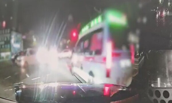 순찰차 앞을 지나는 사설 구급차. photo 연합뉴스